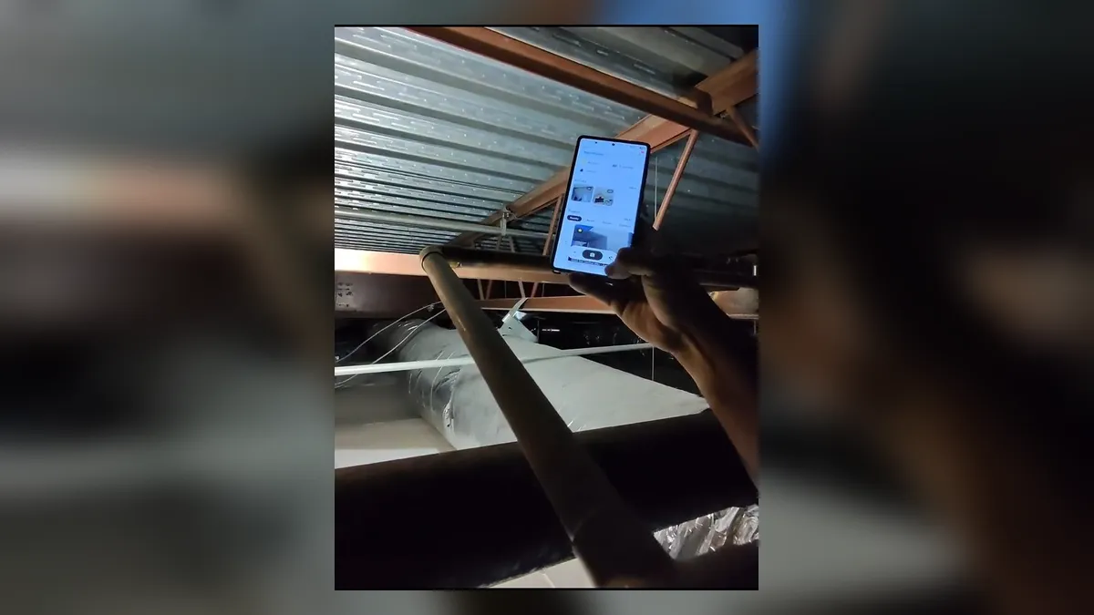 contractor uses a tablet to document overhead commercial plumbing for Maricopa AZ Plumbing Guys