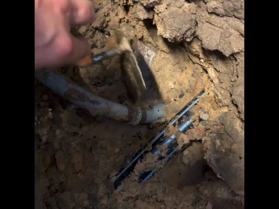 damaged underground pipe is uncovered in a narrow soil excavation for burst pipe repair in maricopa, az in Maricopa