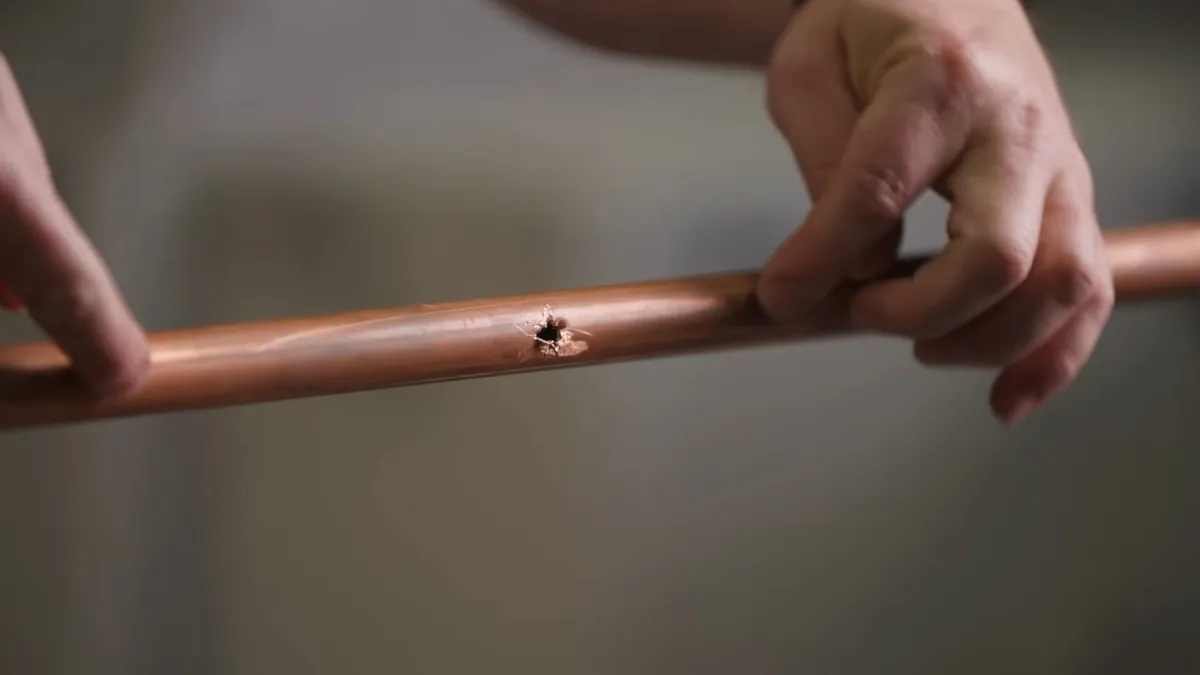 small pinhole is visible in a length of copper water pipe for burst pipe repair in maricopa, az in Maricopa