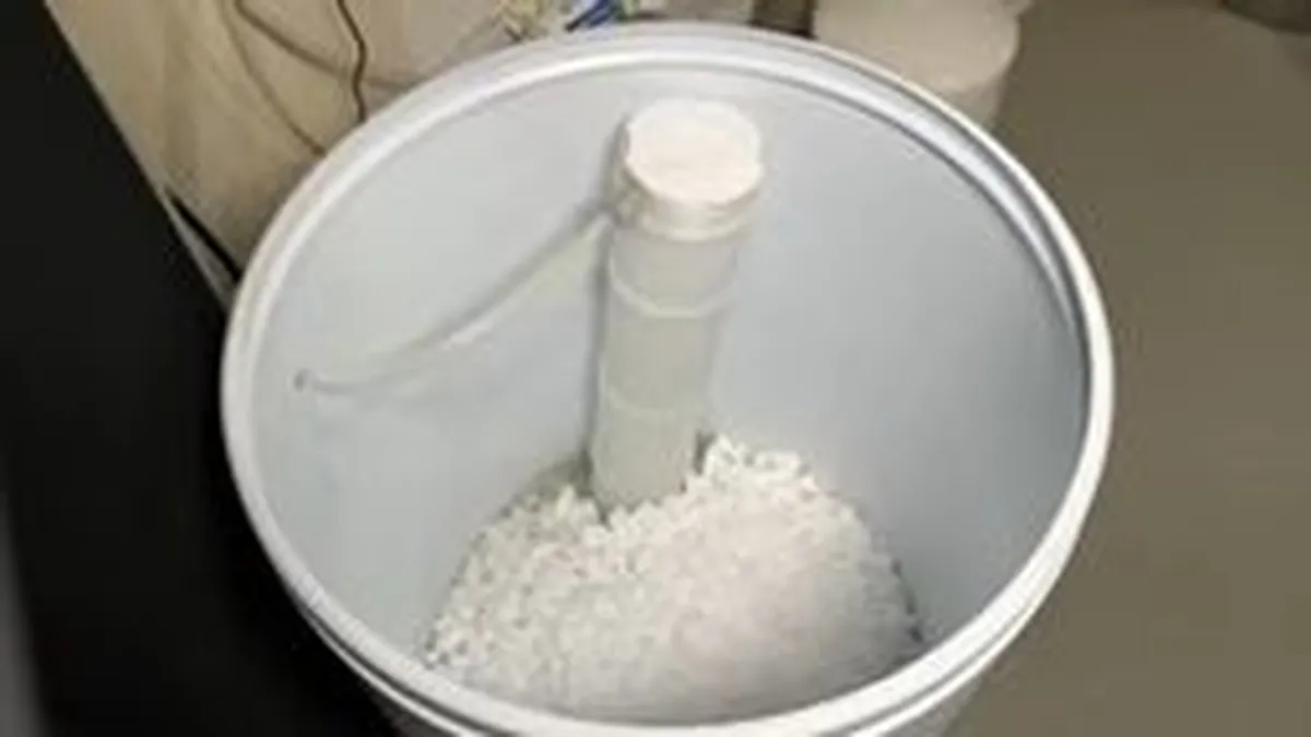 brine tank contains a hard crust of compacted salt around its central tube during a plumbing service call in Maricopa, AZ