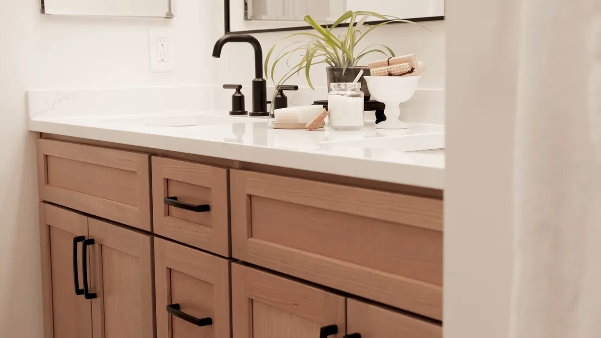 completed bathroom vanity features a white counter and black faucet hardware during a plumbing service call in Maricopa, AZ