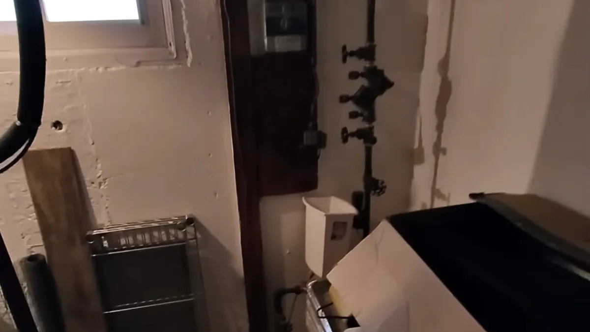 indoor utility room shows exposed valves and piping beside installed equipment during a plumbing service call in Maricopa, AZ