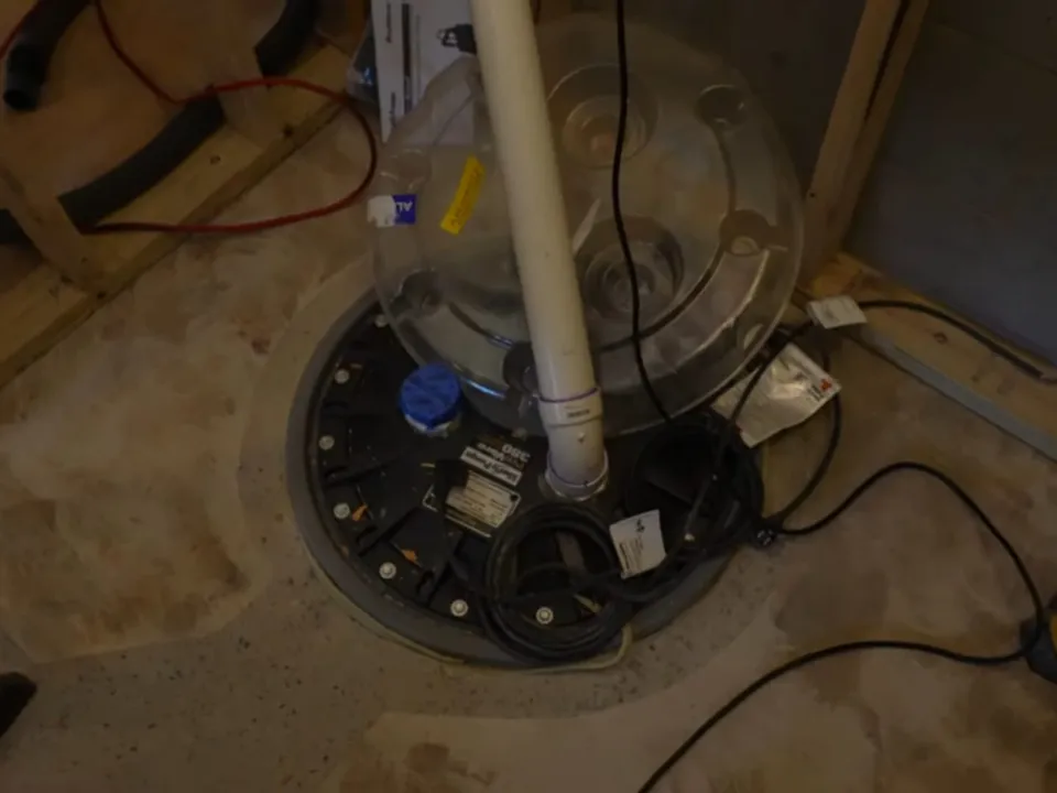 New PVC drain and vent lines rise through an unfinished floor around a toilet flange during a plumbing service call in Maricopa, AZ