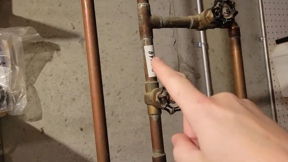 Copper risers, valves, and a shutoff assembly are shown beside a water heater for gas line installation & repair in maricopa, az in Maricopa