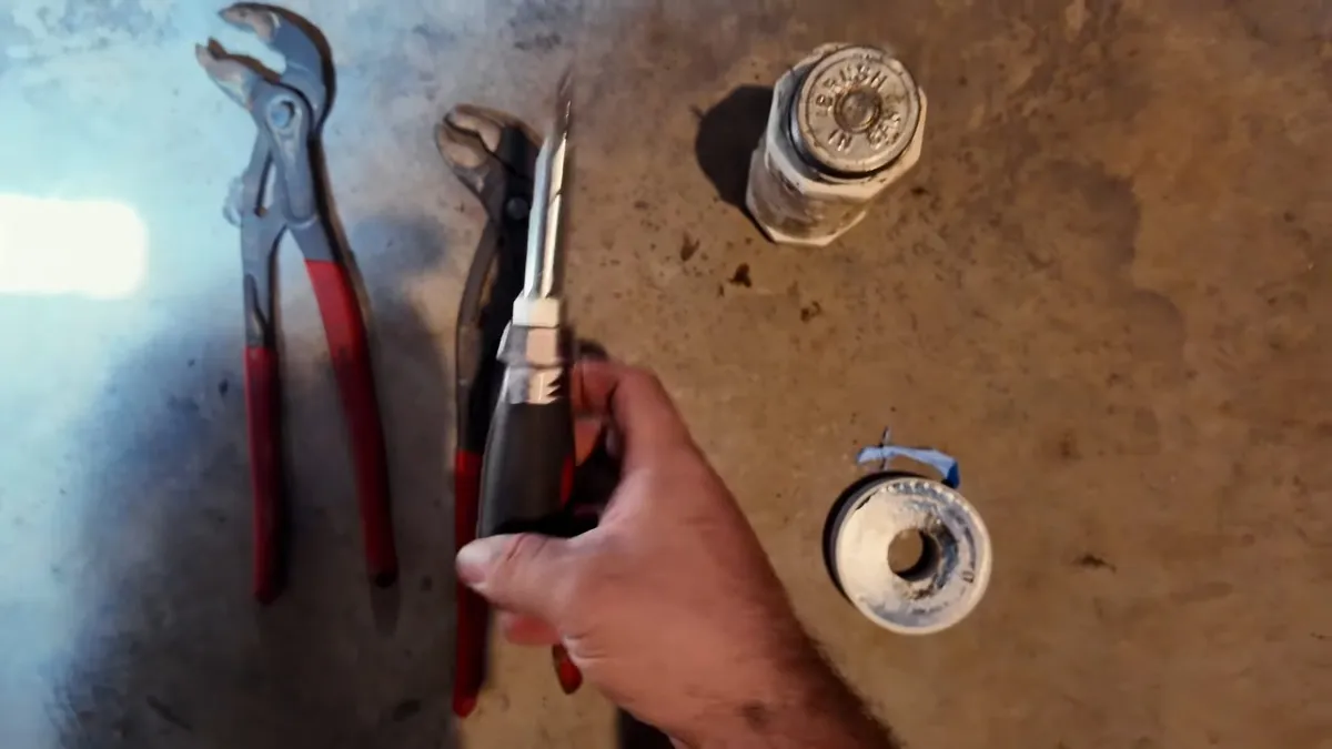 Water-heater fittings, pliers, and a powered tool are arranged for replacement work for gas line installation & repair in maricopa, az in Maricopa