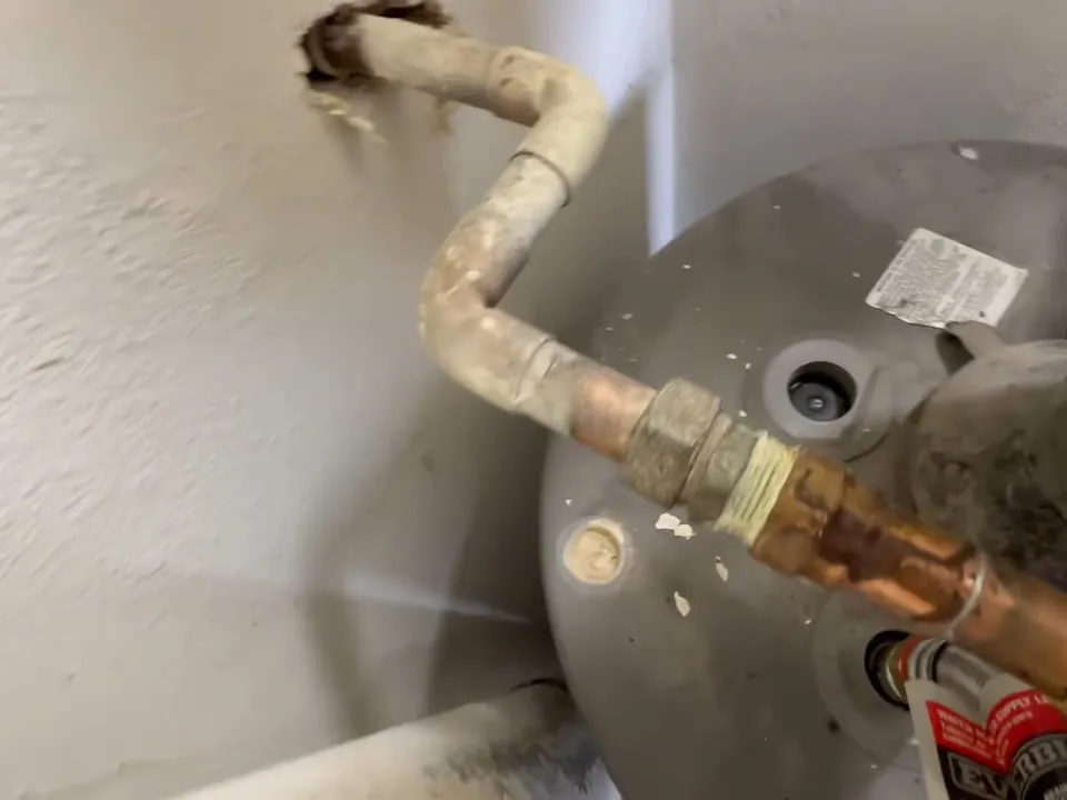long, depleted anode rod is pulled from an aging water heater illustrating How Hard Water from Global Water Resources Shortens Water Heater Life in Maricopa