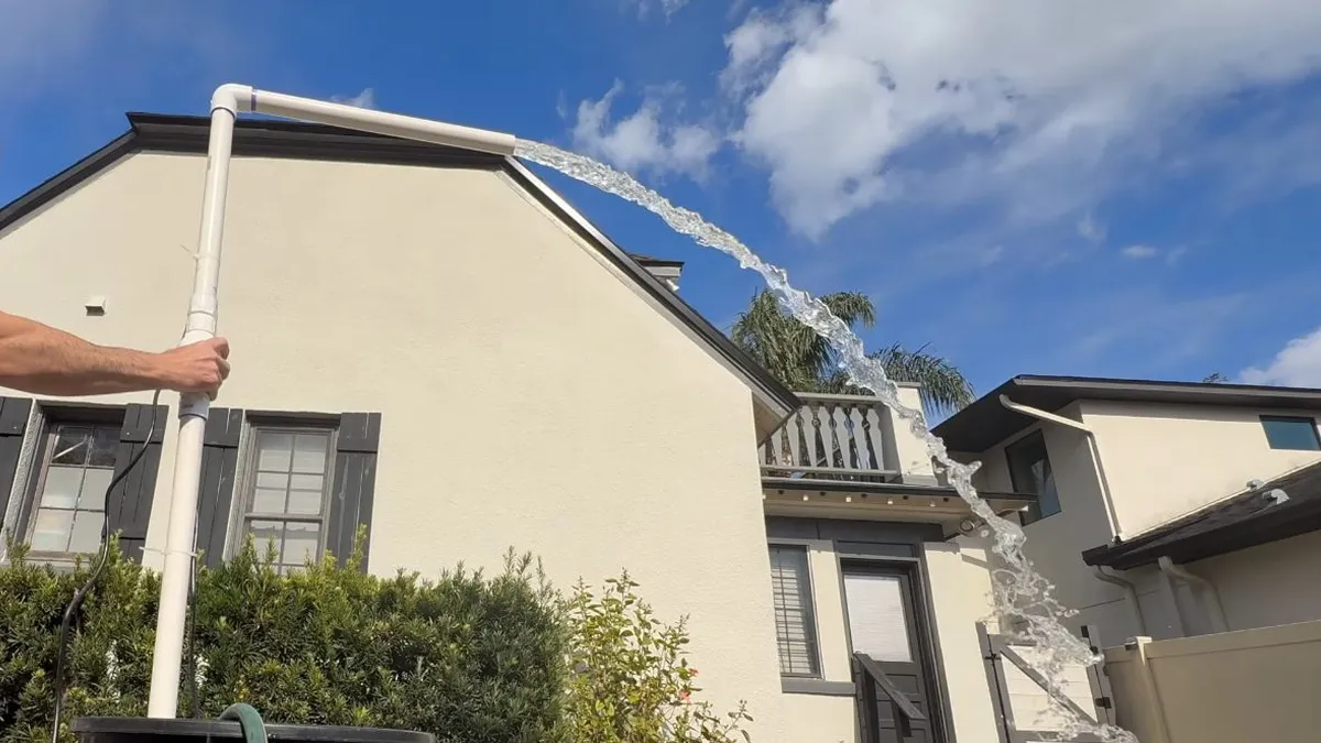 multi-story residential building exterior shows roof drainage and utility lines for Maricopa AZ Plumbing Guys