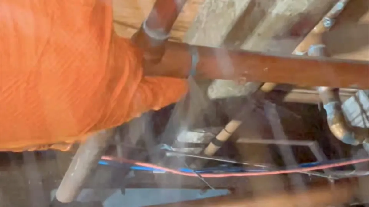 technician inspects supply lines while crawling beneath a raised floor for leak detection in maricopa, az in Maricopa