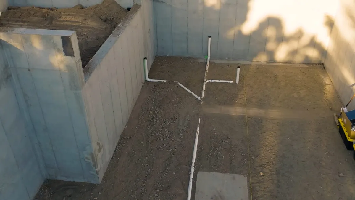 Underground drain piping is laid out before a concrete slab is poured illustrating Why 2005-2015 Maricopa Homes Are Entering Slab Leak Season Right Now