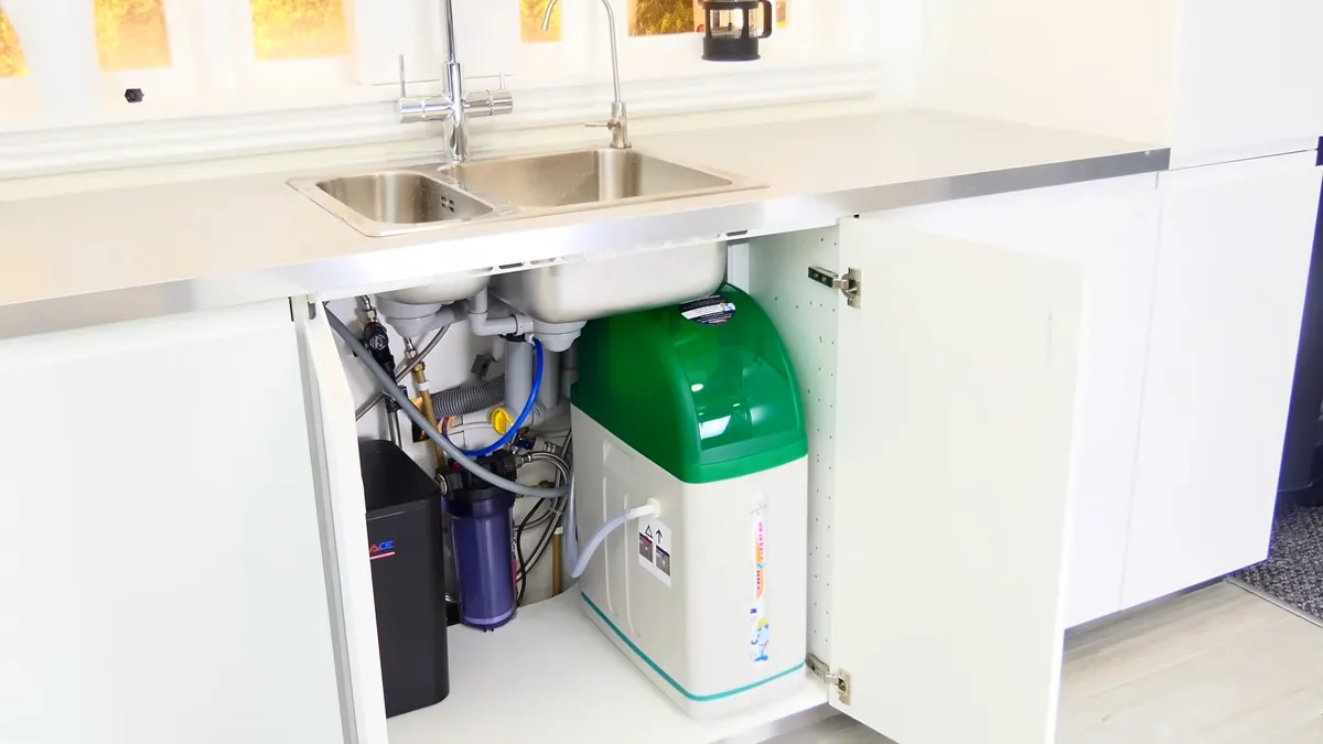compact green treatment tank and filter cartridges fit beneath a kitchen sink for Maricopa AZ Plumbing Guys