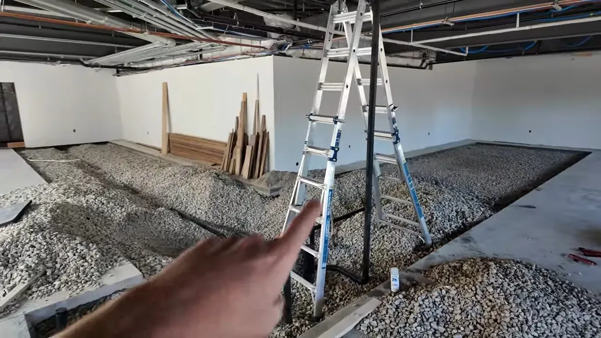 Gravel-filled trenches and pipe routes are visible across a commercial floor during a plumbing service call in Maricopa, AZ
