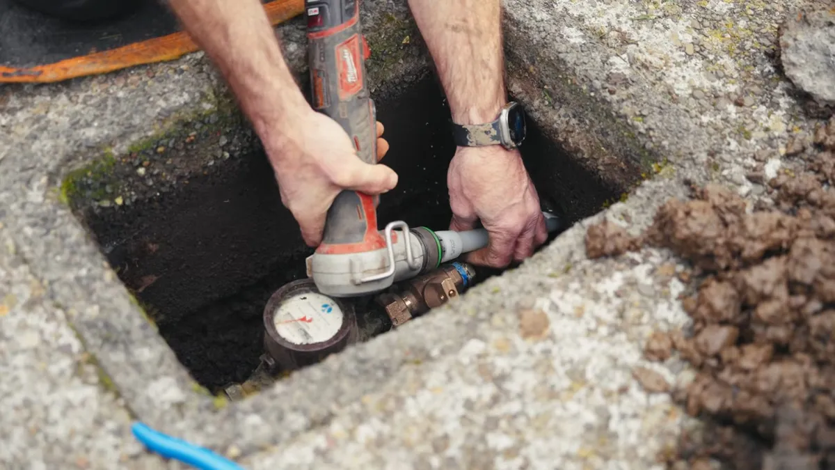 pressure gauge is attached to an underground line during leak testing illustrating Monsoon Season and Your Maricopa Plumbing: What Pinal Valley Soil Does to Buried Pipes