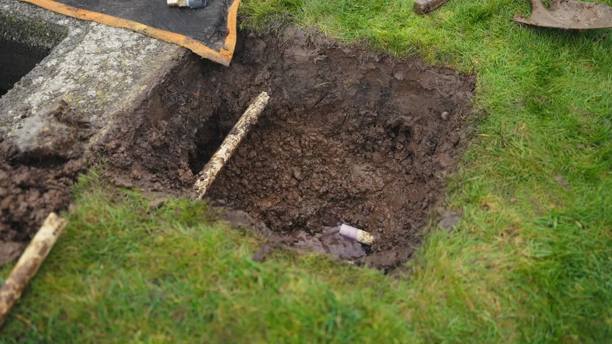 Two excavated yard pits expose the route of a buried utility line illustrating Monsoon Season and Your Maricopa Plumbing: What Pinal Valley Soil Does to Buried Pipes