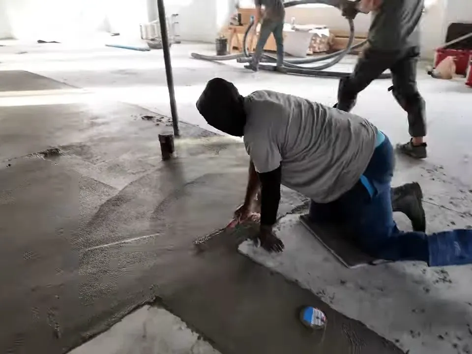 Workers finish concrete around newly installed commercial plumbing lines during a plumbing service call in Maricopa, AZ