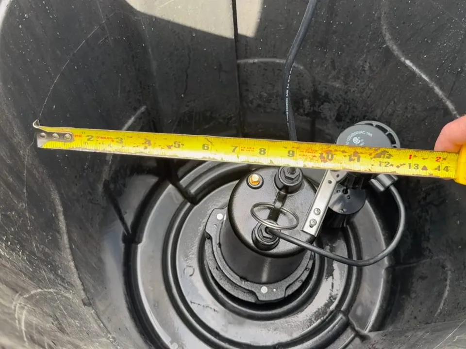 tape measure checks the placement of pump components inside a round basin for pool leak detection & repair in maricopa, az in Maricopa