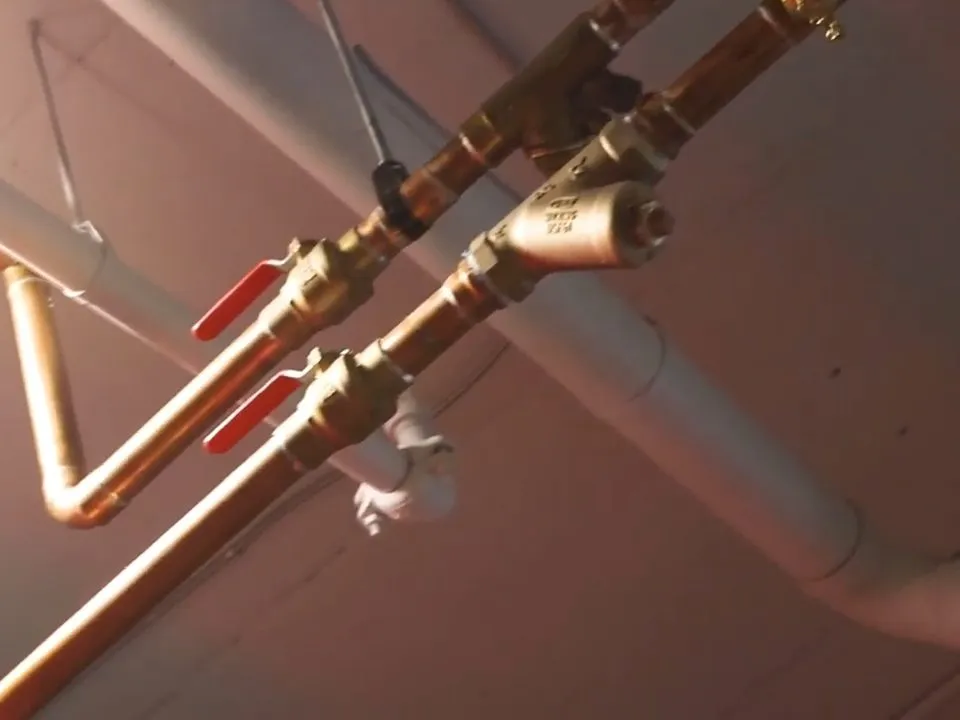Copper and plastic supply lines cross an exposed ceiling during a whole-home rough-in for repiping & whole-home pipe replacement in maricopa, az in Maricopa