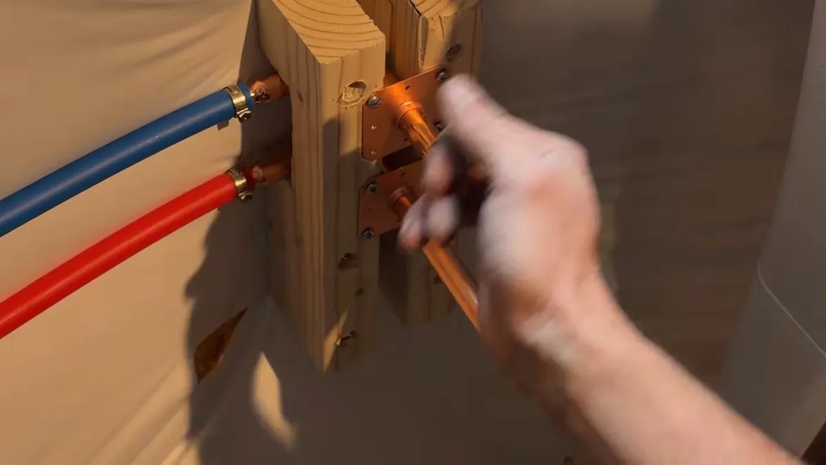 Red and blue water lines are connected inside an open framed wall for repiping & whole-home pipe replacement in maricopa, az in Maricopa