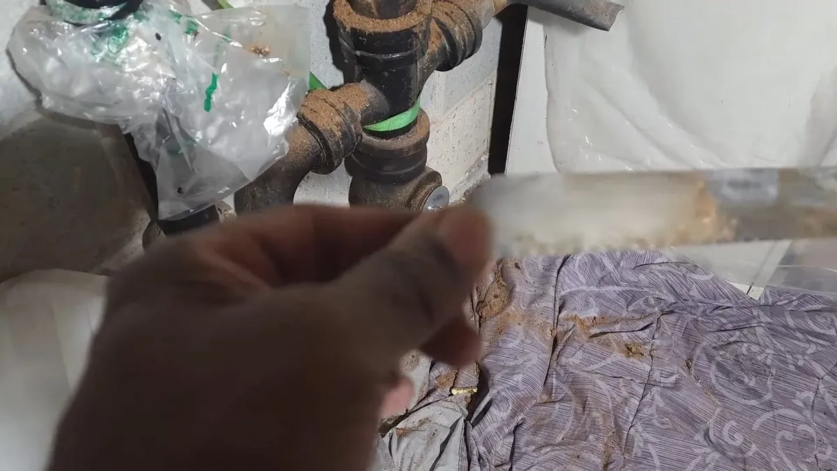 damaged cast iron fitting is wrapped and prepared for a controlled repair for sewer line repair in maricopa, az in Maricopa