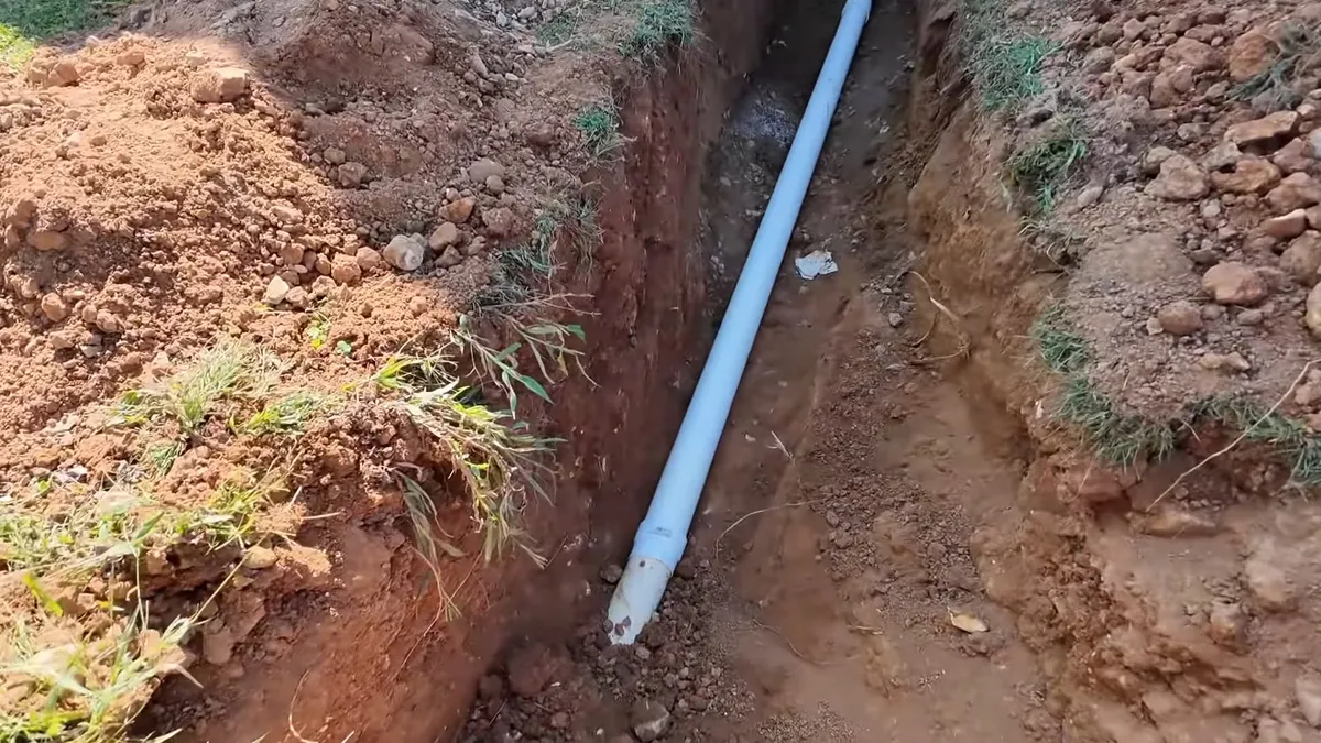 new gray sewer pipe runs through a freshly excavated trench for sewer line replacement in maricopa, az in Maricopa