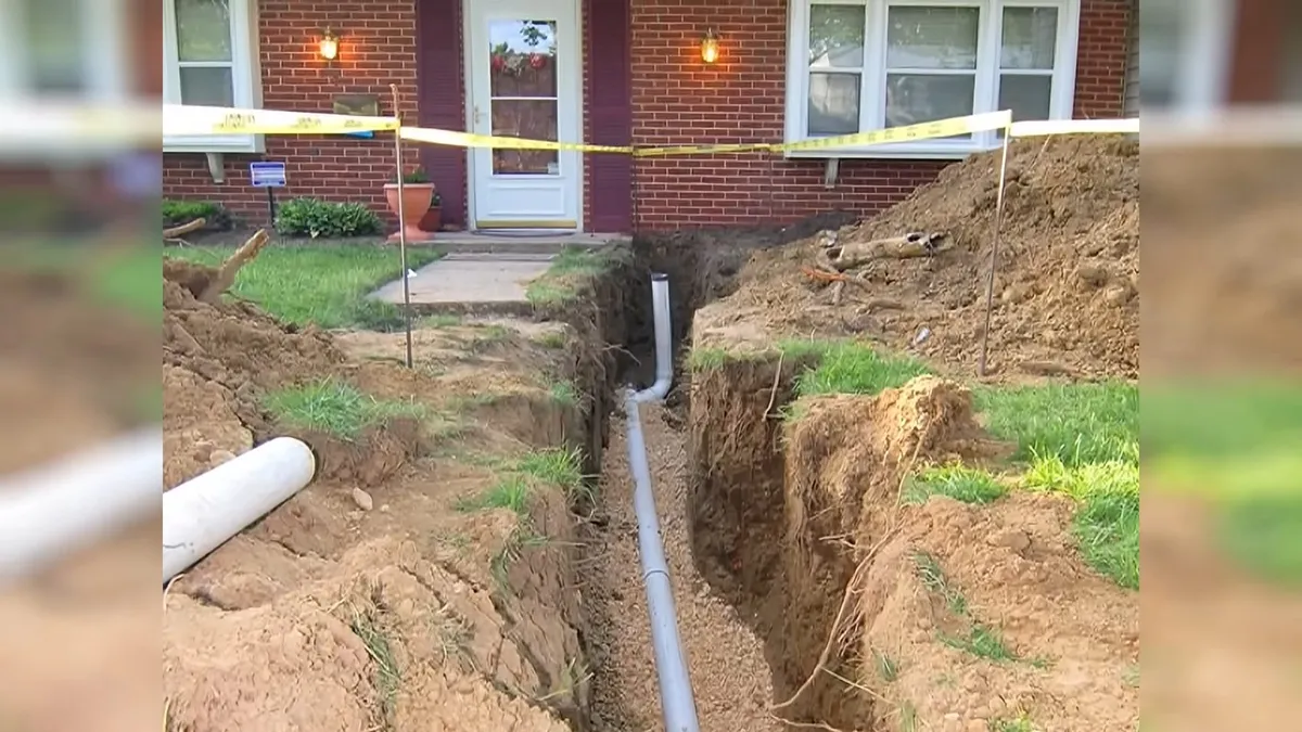 yard trench carries a replacement or lined sewer connection toward a house for sewer line replacement in maricopa, az in Maricopa
