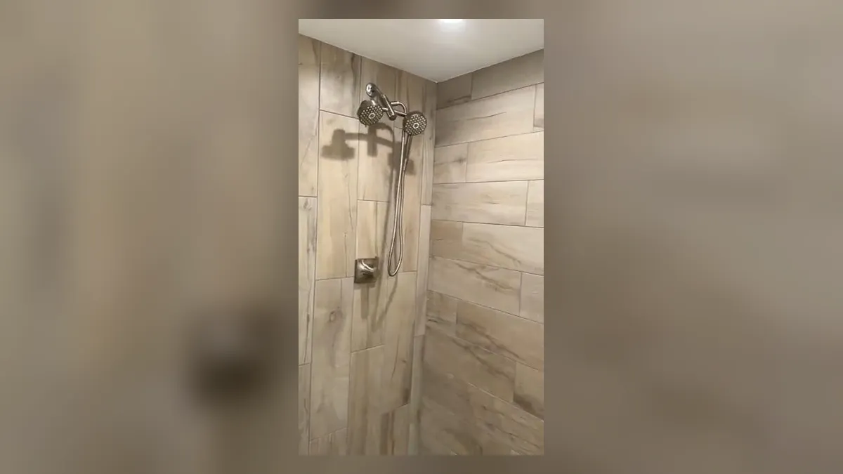completed tiled shower has a glass door and multiple shower heads for shower & bathtub installation in maricopa, az in Maricopa