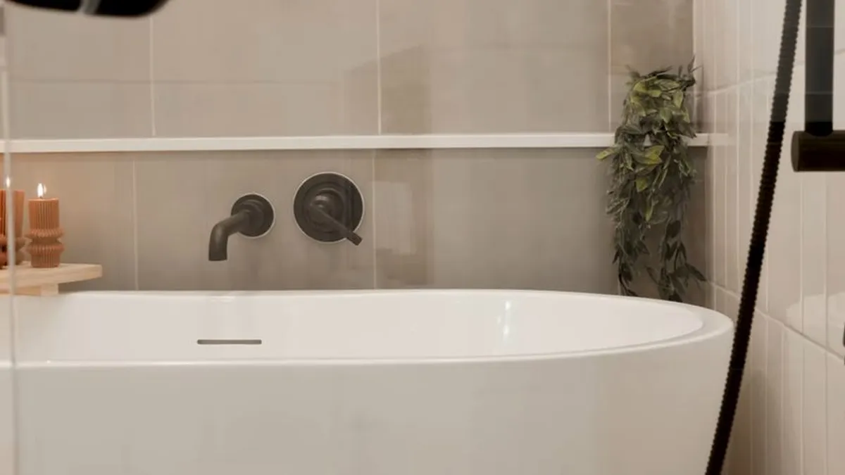 finished white soaking tub sits beneath matte-black wall-mounted fixtures for shower & bathtub installation in maricopa, az in Maricopa