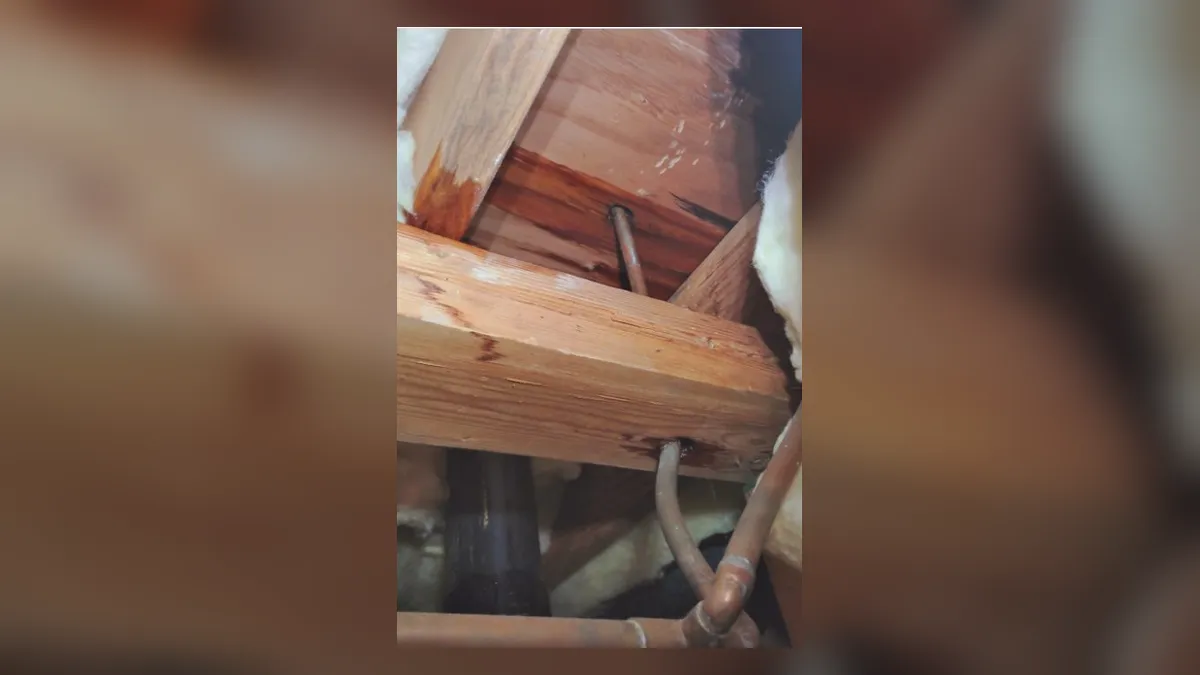 supply pipe runs through an open wall or attic framing cavity illustrating Slab Leak Detection and Repair Cost in Maricopa, AZ: What to Expect in 2025