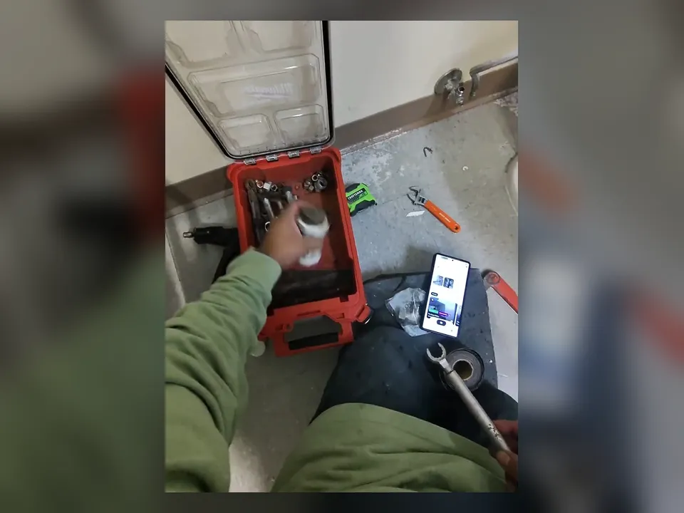 technician views a drain camera feed while inspecting a commercial floor line during a plumbing service call in Maricopa, AZ