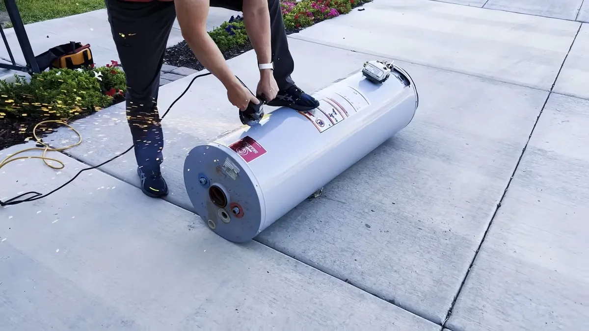 tank water heater lies on a driveway after removal from the home illustrating Tank vs. Tankless Water Heater in Maricopa, AZ: What to Know Before You Switch