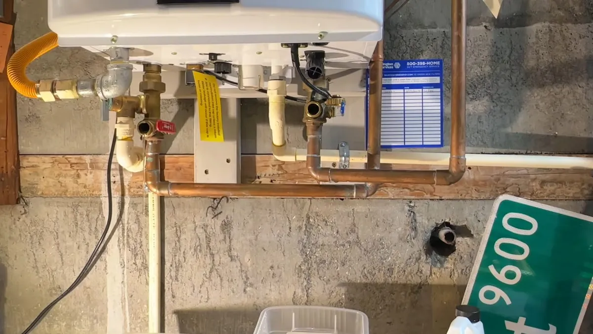 tankless heater is connected to valves, hoses, and a diagnostic display on a wall for tankless water heater services in maricopa, az in Maricopa