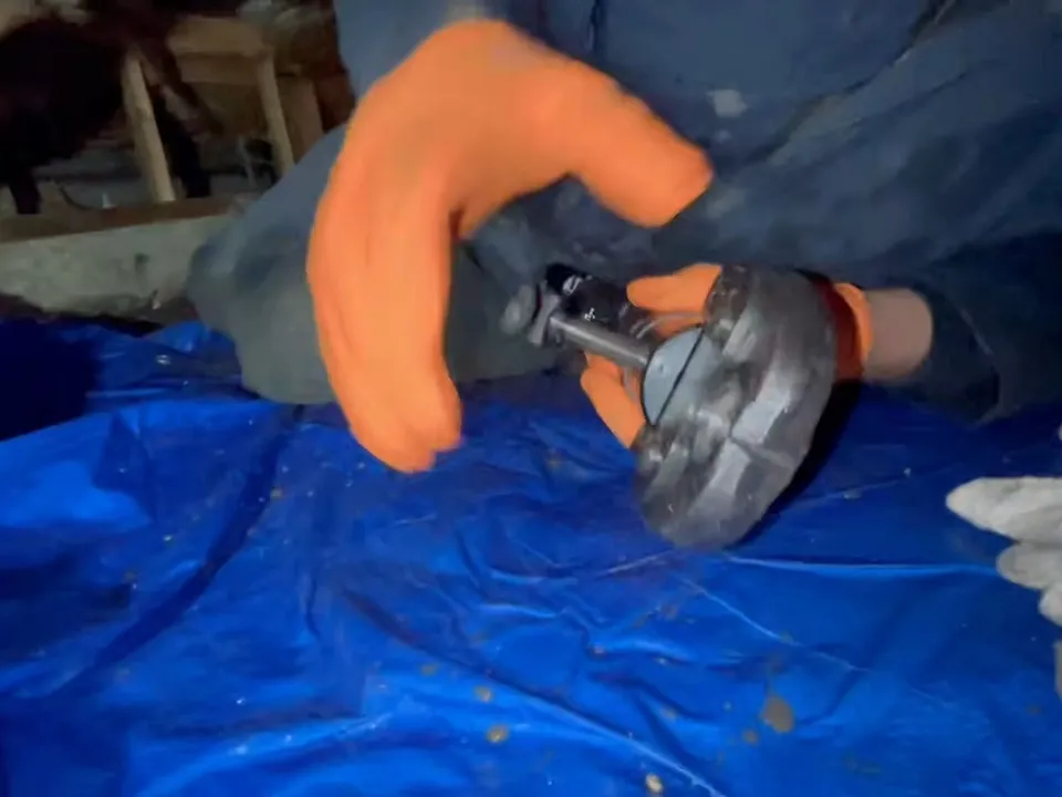 compact cutter is used on an underfloor pipe over protective sheeting during a plumbing service call in Maricopa, AZ