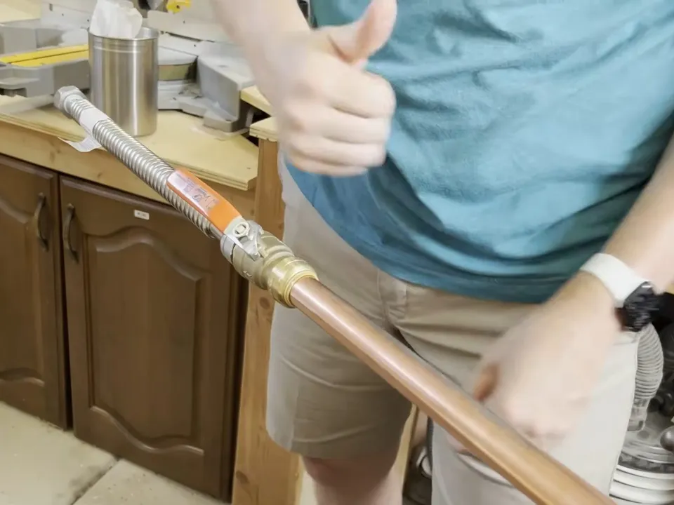 plumber prepares a copper pipe end for a new fitting during a plumbing service call in Maricopa, AZ