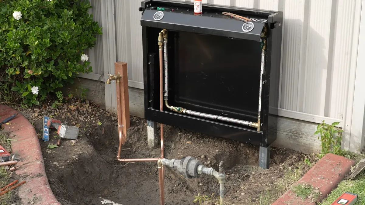 large exterior whole-house filtration unit is mounted beside a building for water filtration installation in maricopa, az in Maricopa