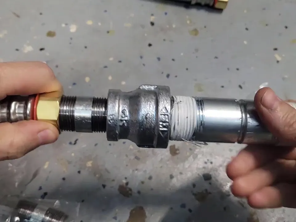 metal connector joins copper tubing to a water-heater fitting for water heater installation & replacement in maricopa, az in Maricopa