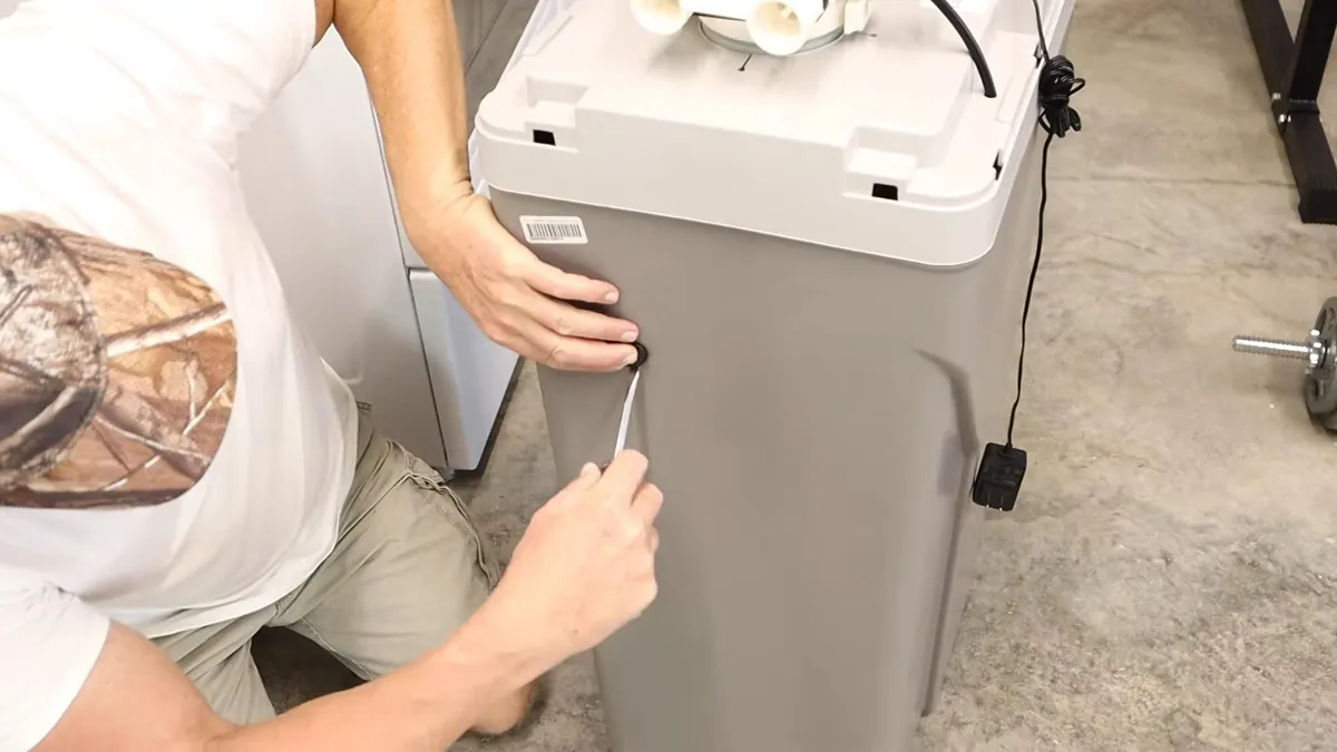 technician secures the top assembly on a gray water-softener tank for water softener installation & repair in maricopa, az in Maricopa