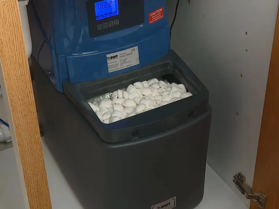 White salt pellets fill the open brine tank beside a blue softener head illustrating Water Softener Sizing for Maricopa Homes: Why 25-35 GPG Requires a Different Calculation