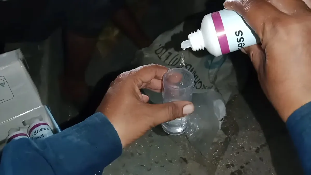 Reagent drops are added to a clear water sample during a hardness test illustrating What's in Your Maricopa Water? A Plain-English Guide to the Global Water Resources Annual Report